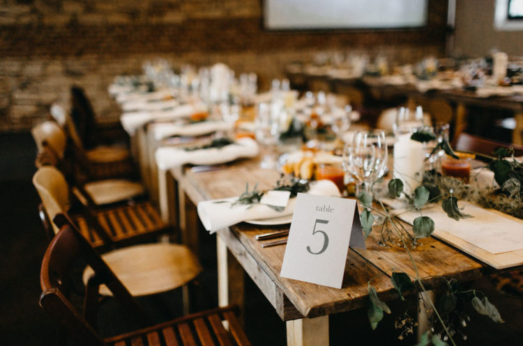 The tablescape was rustic and simple, with greenery garlands and white candles