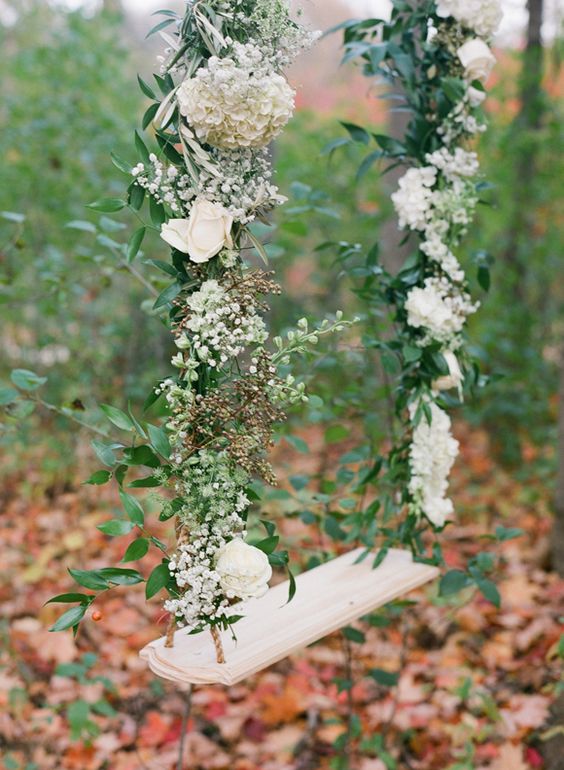 a subtle swing with greenery, baby's breath and white blooms