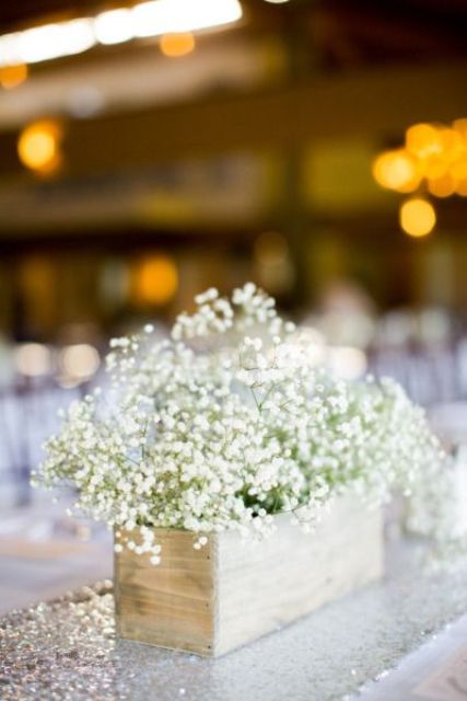 a wooden box with baby's breath is a cool idea for a rustic wedding