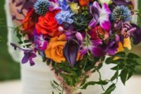 10 chic bouquet with red, orange, violet and fuchsia blooms and a cool texture