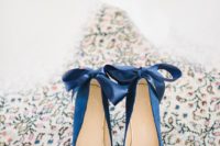 10 navy suede heels with ribbon bows on the back