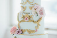 11 The wedding cake was done in aqua with fresh pink blooms and gold detailing