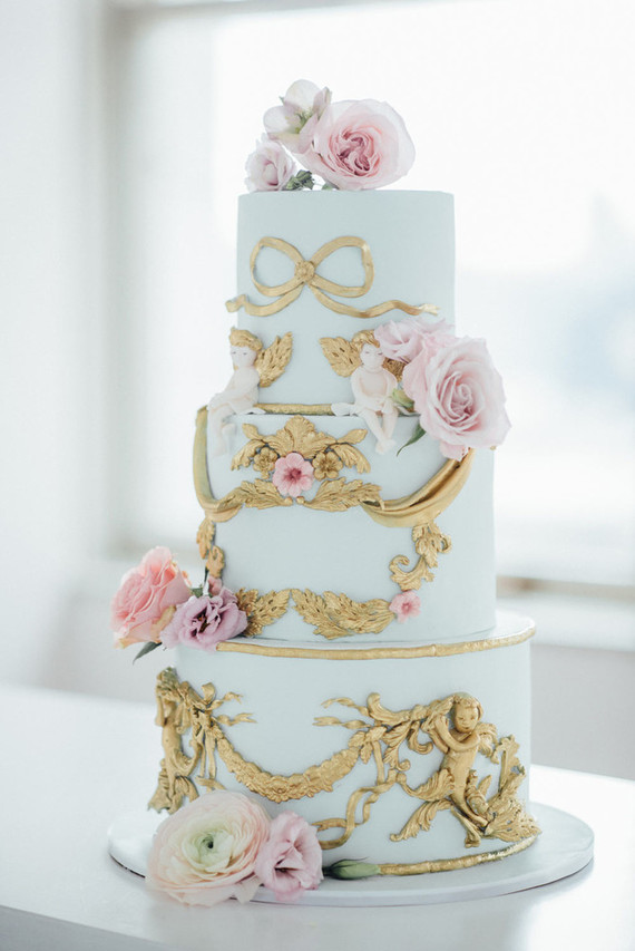 The wedding cake was done in aqua with fresh pink blooms and gold detailing