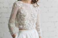 11 a plain ivory skirt with pleats and a floral applique ctop top with sleeves