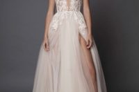11 white plunging neckline wedding dress with cap sleeves and a flowy skirt with a side slit