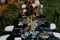13 dark fall tablescape with oversized florals, black linens, gold cutlery