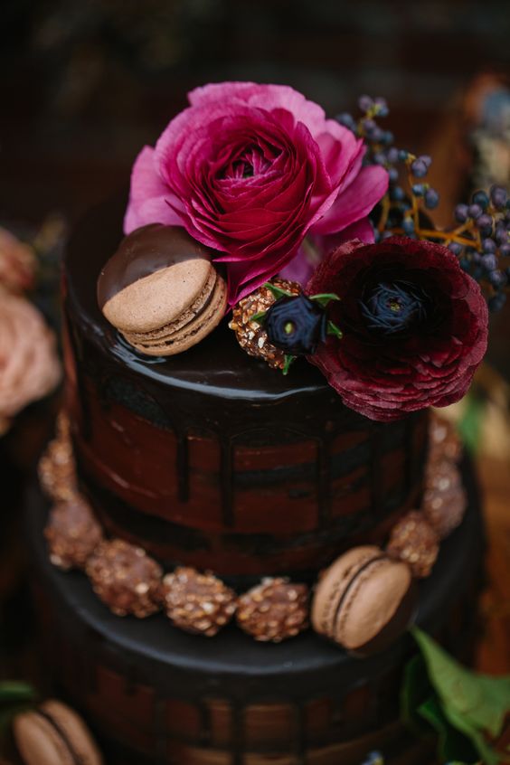 red velvet chocolate drip wedding cake with fresh blooms and macarons