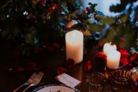 14 dark tablescape with textural greenery, red rose petals and candles