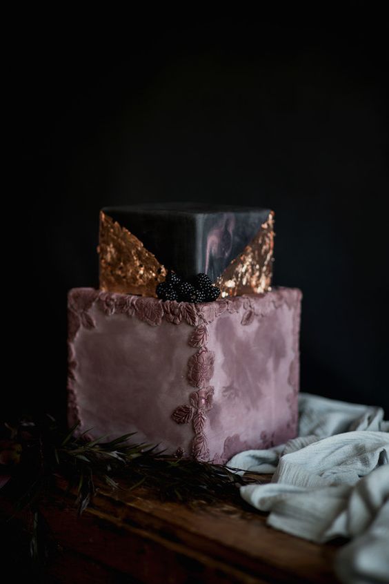 mauve and black wedding cake with gold leaf decor and icing flowers and blackberries