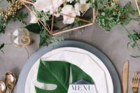 15 a large leaf for the setting and a greenery table runner with white blooms
