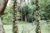 16 fall-inspired swing with greenery and pink and red flowers