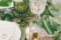 16 interwine each place setting with fresh leaves, add green platters and glasses to echo