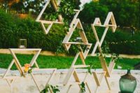 17 triangle installation with greenery and some blooms