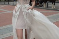 18 ivory deep V neckline heavily embellished wedding dress with an overskirt and pockets