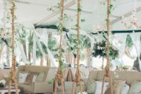 19 hang some whimsical wooden swings in the reception area and decorate them with greenery