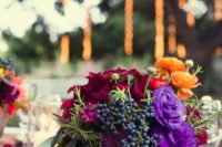 19 lovely low box centerpiece with burgundy, violet and orange blooms and blue berries