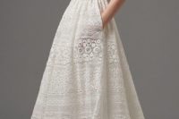 20 boho-inspired lace wedding dress featuring sheer pockets and patterns of eyelet lace, floral motifs