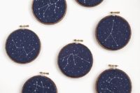 20 embroidery hoops with navy fabric and embroidered constellations as favors