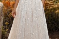 20 sparkling halter neckline border sleeve wedding dress with an illusion neckline and a sparkling textural skirt