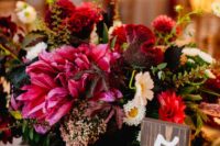 21 dark pink and bold red lush floral centerpiece with grapes wows