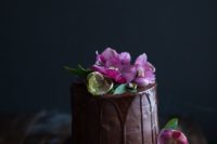 22 chocolate wedding cake with chocolate dripping and bold purple blooms
