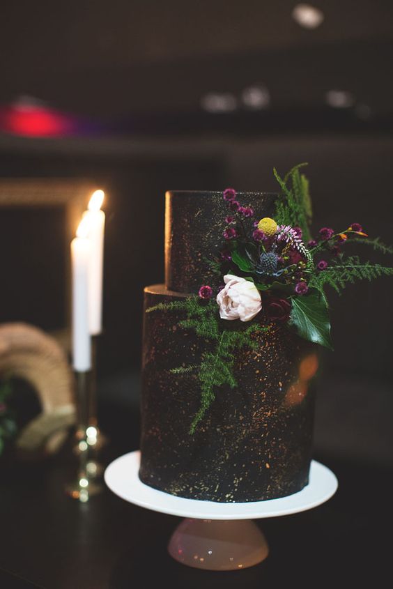 dark chocolate cake with copper detailing and fresh flowers