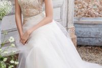 23 a romantic ivory wedding dress with a tulle skirt and a lace bodice with cap sleeves