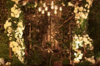 23 candle holders hanging over the wedding arch for soft romantic light