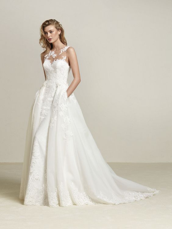 illusion strapless neckline wedding dress with lace appliques, a detachable overskirt with pockets