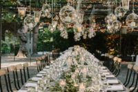 24 candle lanterns in spheric and drop shapes and lights over the reception