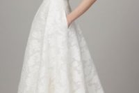 25 lace A-line wedding dress with a deep V neckline, spaghetti straps and pockets