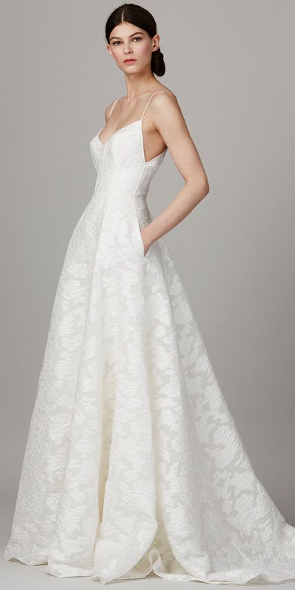 lace A-line wedding dress with a deep V neckline, spaghetti straps and pockets