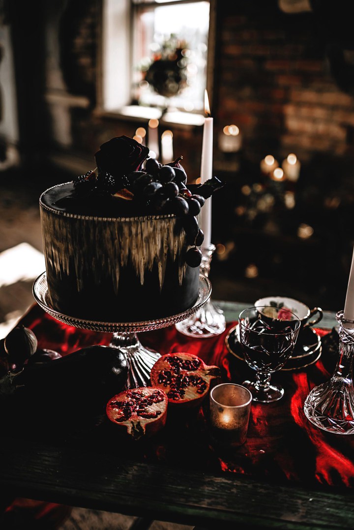 gorgeous black metallic gold wedding cake with blackberries, grapes and dark roses
