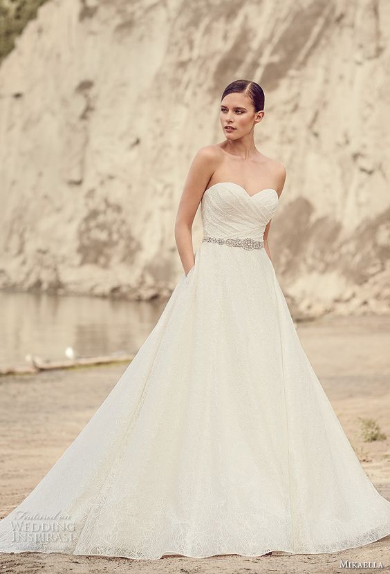 ruched strapless wedding dress with an embellished belt and pockets