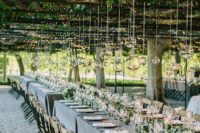 27 string lights and candle lanterns hanging from the vines