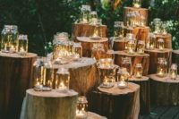 27 tree stumps wedding altar with candles in mason jars
