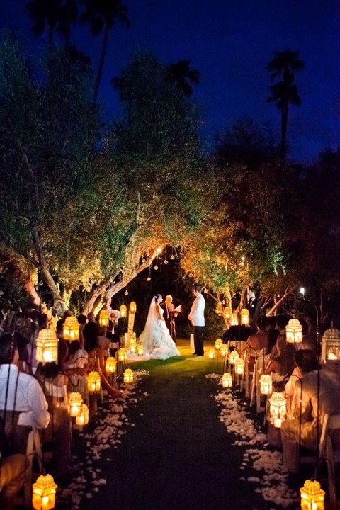 candle holders on the wedding arch and lanterns to line up the aisle