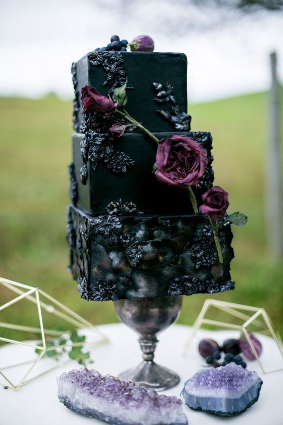 dramatic square wedding cake with flower and berry icing decor and fresh blooms