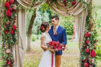 28 hot red and burgundy flowers on the arch with flowy fabric