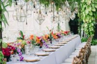 28 lush greenery decor over the table with geometric lanterns
