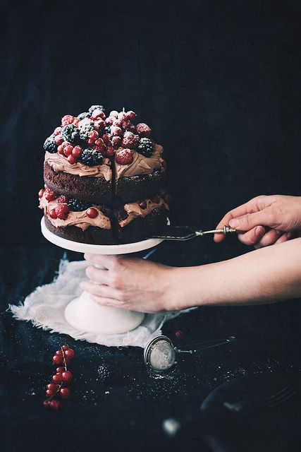 naked wedding cake with fresh berries and sugar powder