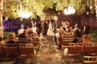 30 crystal chandeliers and candle holders hanging over the whole ceremony space