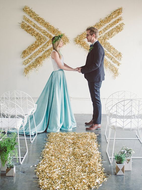 gold glitter ceremony backdrop of chevrons made on the wall
