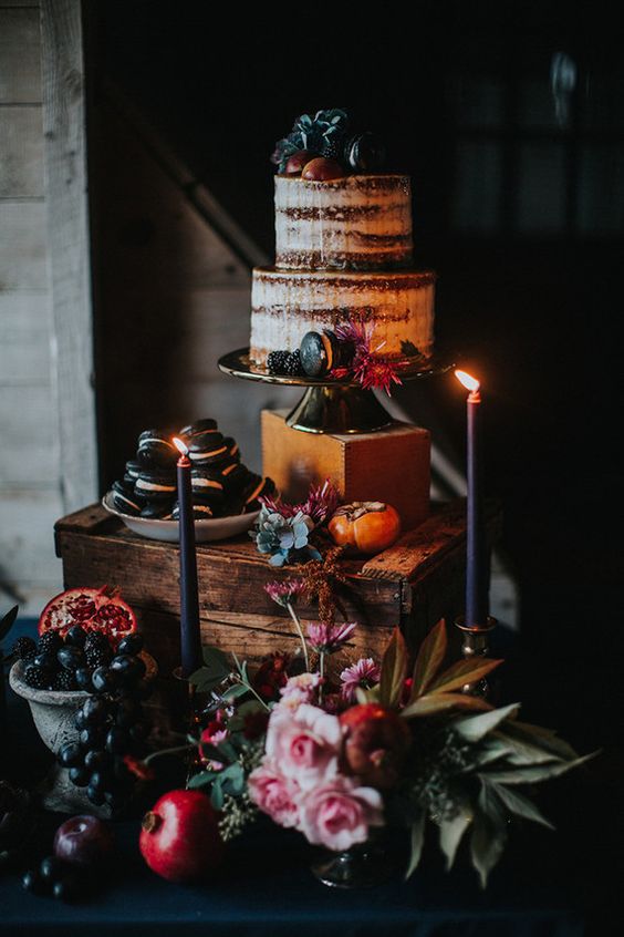 semi naked wedding cake with blackberries and black macarons