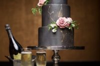 32 black wedding cake with gold constellation and fresh roses