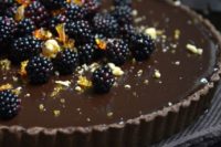 32 dark chocolate tart with blackberries and hazelnut pralines