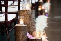 32 tree stumps with white petals and candle holders