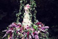 32 very lush hanging floral cake display for a garden wedding