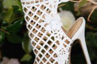 34 white laser cut wedding bootie with a peep toe and floral detailing