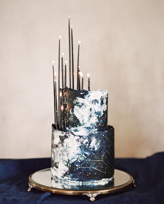 unique constellation wedding cake in navy and black with thin black candles
